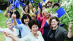 Frauen schwenken Flaggen des Frauenbundes. Foto: Angelika Bardehle